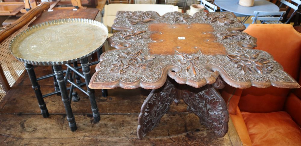 An Indian carved oak folding table and a brass tray top table, larger W.78cm x D.76cm, H.48cm